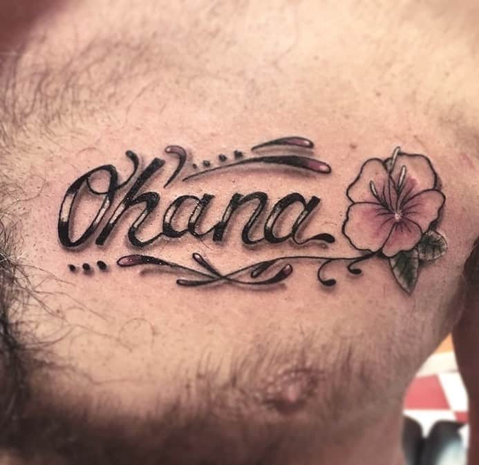 Script-style 'Ohana' tattoo with a pink hibiscus flower, symbolizing family, love, and Hawaiian culture.