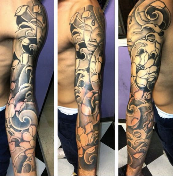 Full-sleeve tattoo with intricate floral and abstract designs in black and shaded hues