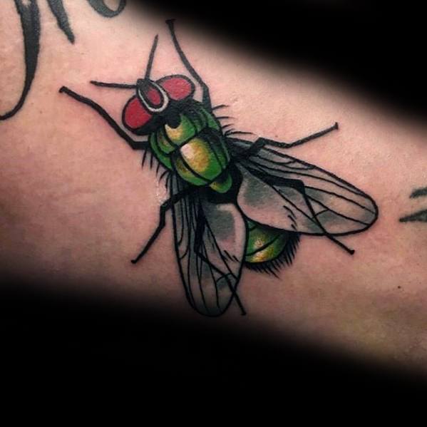 Vibrant green and yellow fly tattoo with red eyes and detailed wings, shaded for a bold and realistic look on the forearm.
