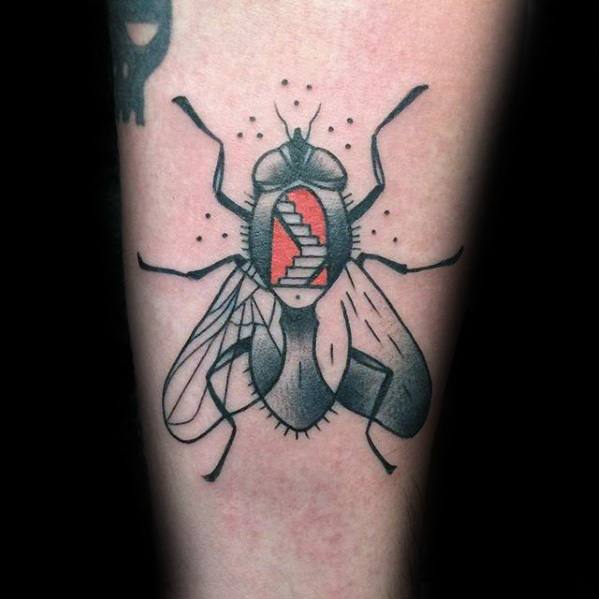 Abstract fly tattoo with black and grey shading and a red staircase inside the body, blending surreal and geometric elements.