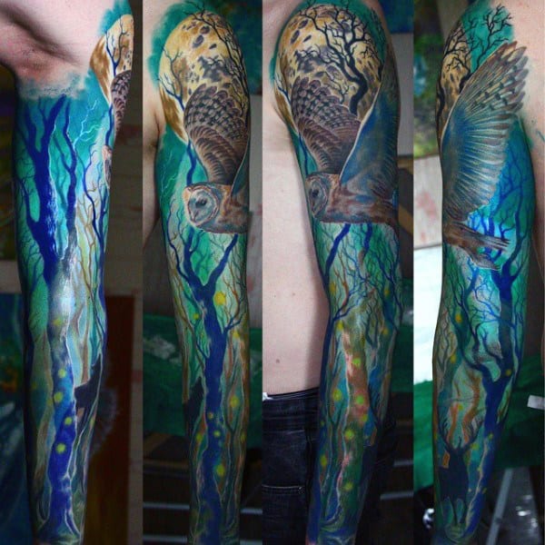Vibrant full-sleeve tattoo featuring a majestic owl soaring through an ethereal blue forest, blending realism with abstract elements for a mystical effect.