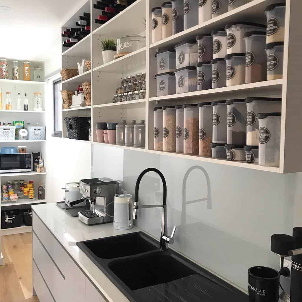 large kitchen wall cabinet with plastic storage bins and wine bottles