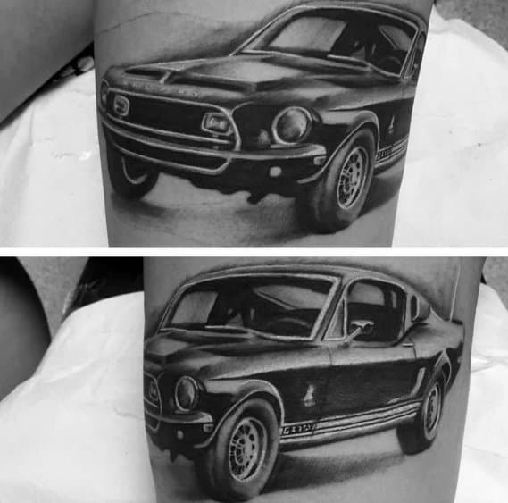 Black and grey Ford Mustang Shelby GT500 tattoo on arm, showcasing a realistic muscle car design with intricate shading and fine details.