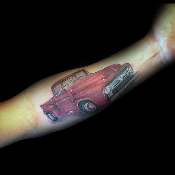Colorful Ford classic truck tattoo on forearm, featuring a vibrant red vintage pickup with realistic shading and a nostalgic design.