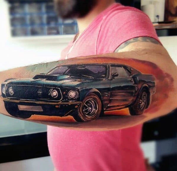 Vibrant Ford Mustang tattoo on forearm, featuring a detailed black muscle car with realistic shading, depth, and a dynamic background effect.