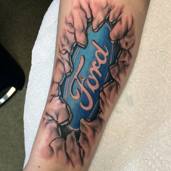 Ford logo tattoo on forearm with a ripped-skin effect, featuring a bold blue emblem surrounded by realistic torn flesh detailing.