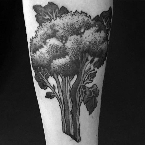 Black and gray broccoli tattoo on the forearm, featuring intricate shading and bold details for a striking and realistic design.