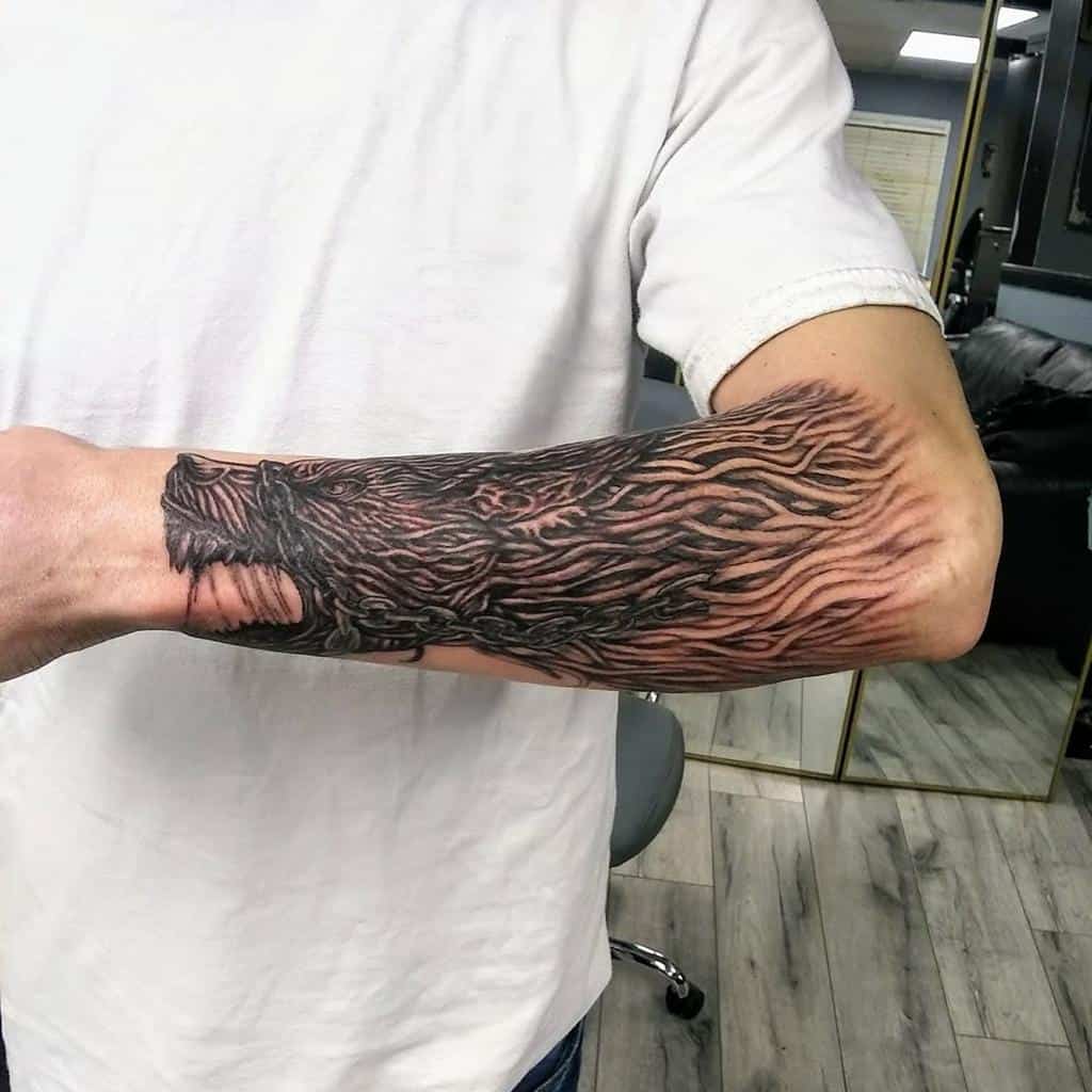 Forearm tattoo depicting Fenrir's fur in dynamic, flowing detail, symbolizing the Norse wolf's raw power and energy