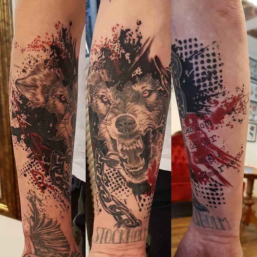 Forearm tattoo of Fenrir with fierce red accents, chained details, and splatter effects, capturing a dynamic Norse mythology theme