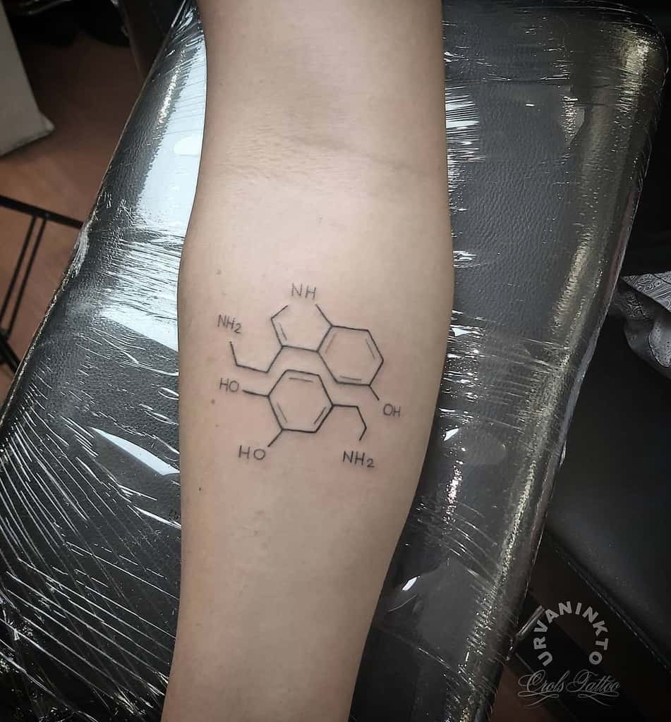 A tattoo of the serotonin chemical structure on an arm