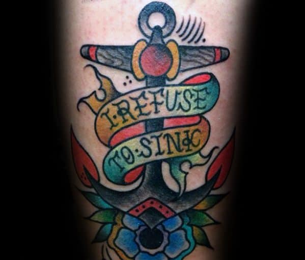 Refuse to sink: anchor tattoo with flowers and banner stating resilience