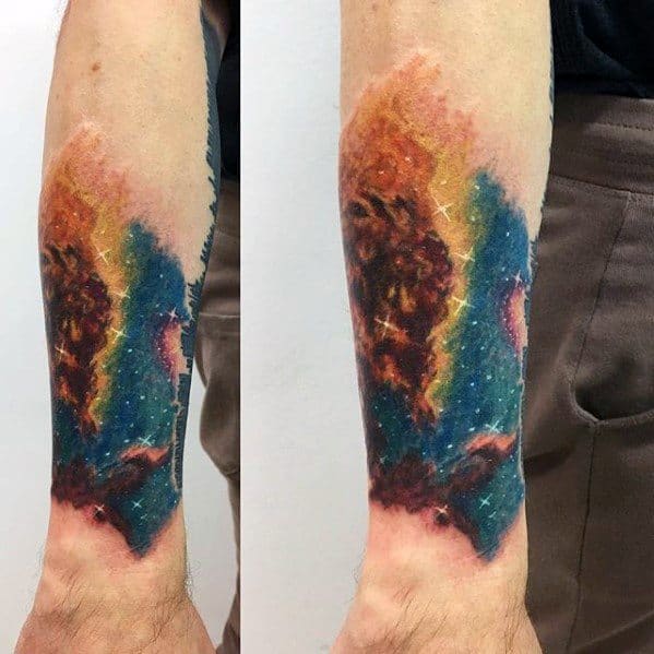 Forearm nebula tattoo showcasing a colorful galaxy with stars and vibrant nebulae
