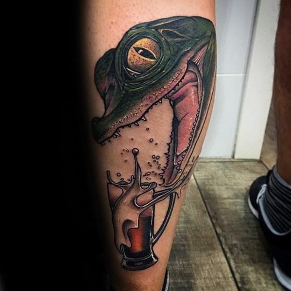 Vibrant tattoo of a frog with its mouth wide open, dramatically gulping down a foaming beer mug, blending surrealism and bold color for a playful twist.