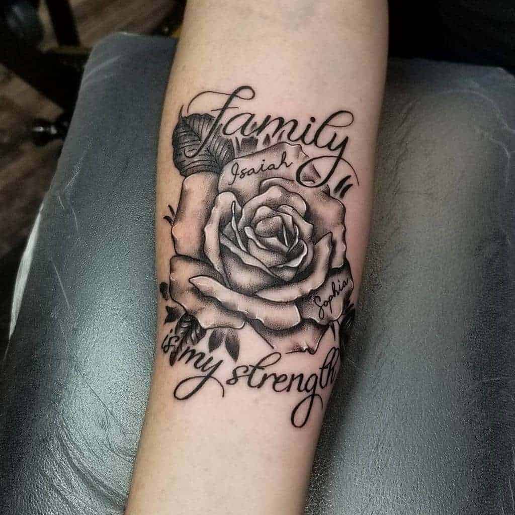 Tattoo of a black and white rose with "Family is my strength" and names "Isaiah" and "Sophia"