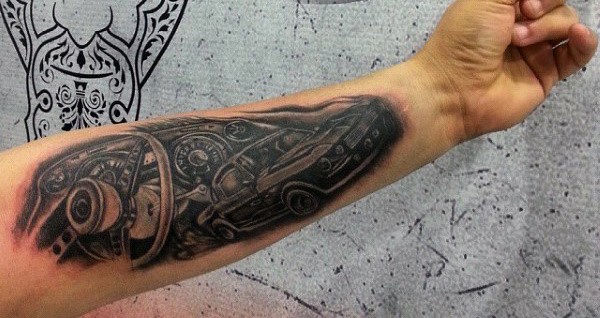Forearm tattoo featuring a realistic image of car engine parts creating an intricate mechanical design