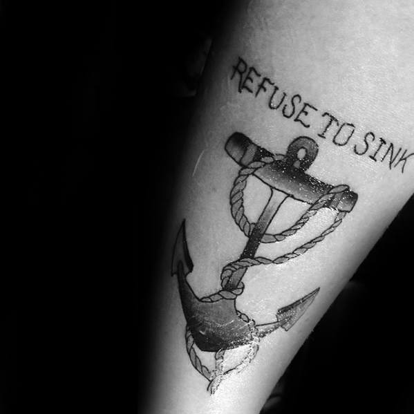 Black and gray tattoo of the phrase "Refuse to Sink" above a detailed anchor wrapped with rope