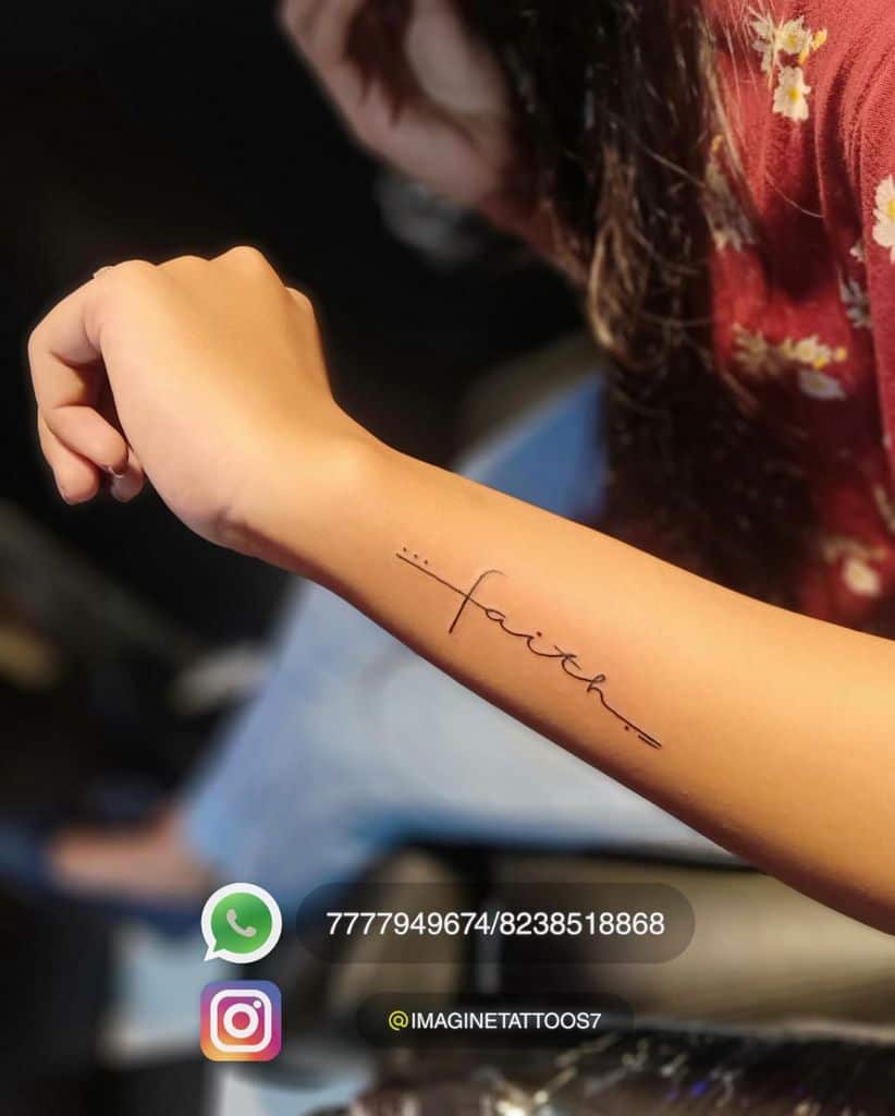Forearm tattoo with "faith" in cursive script
