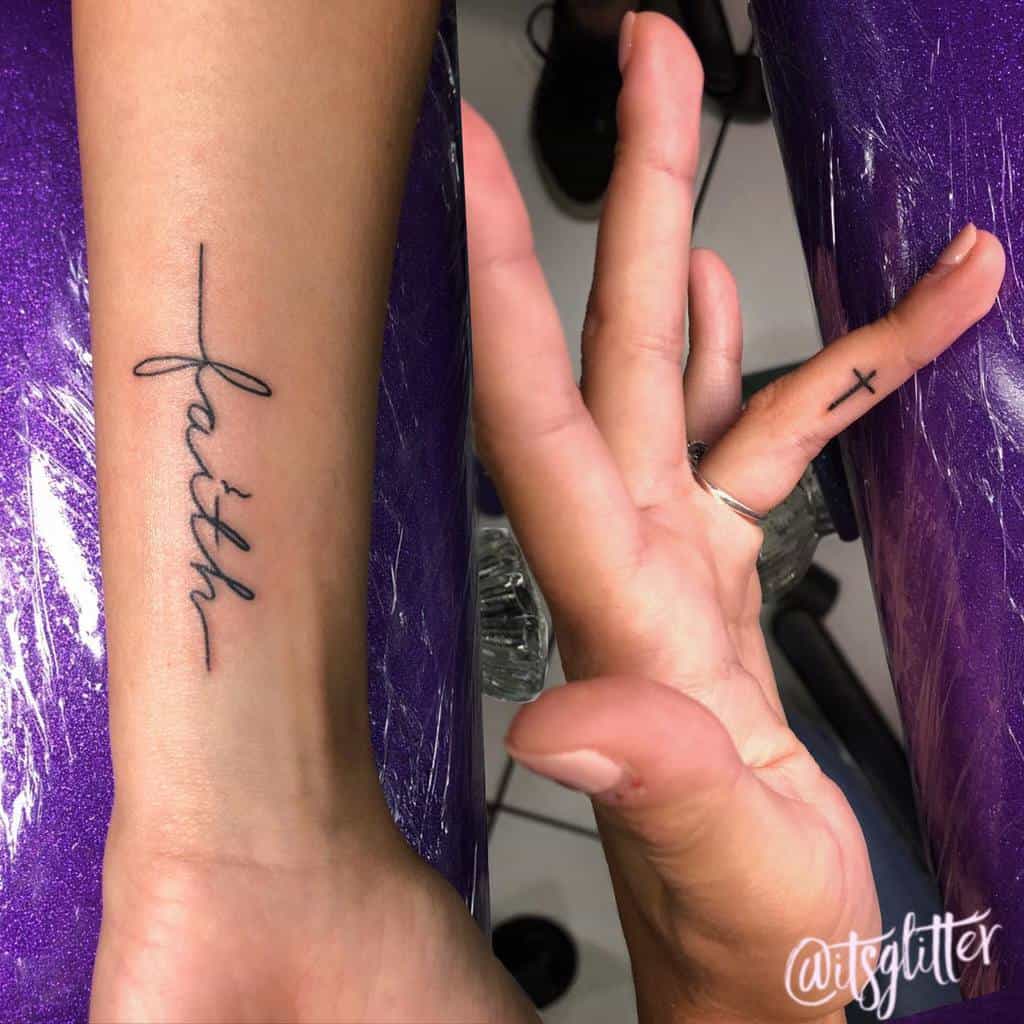 Two hands adorned with tattoos: the word "faith" elegantly inked on one wrist and a delicate cross etched on a finger