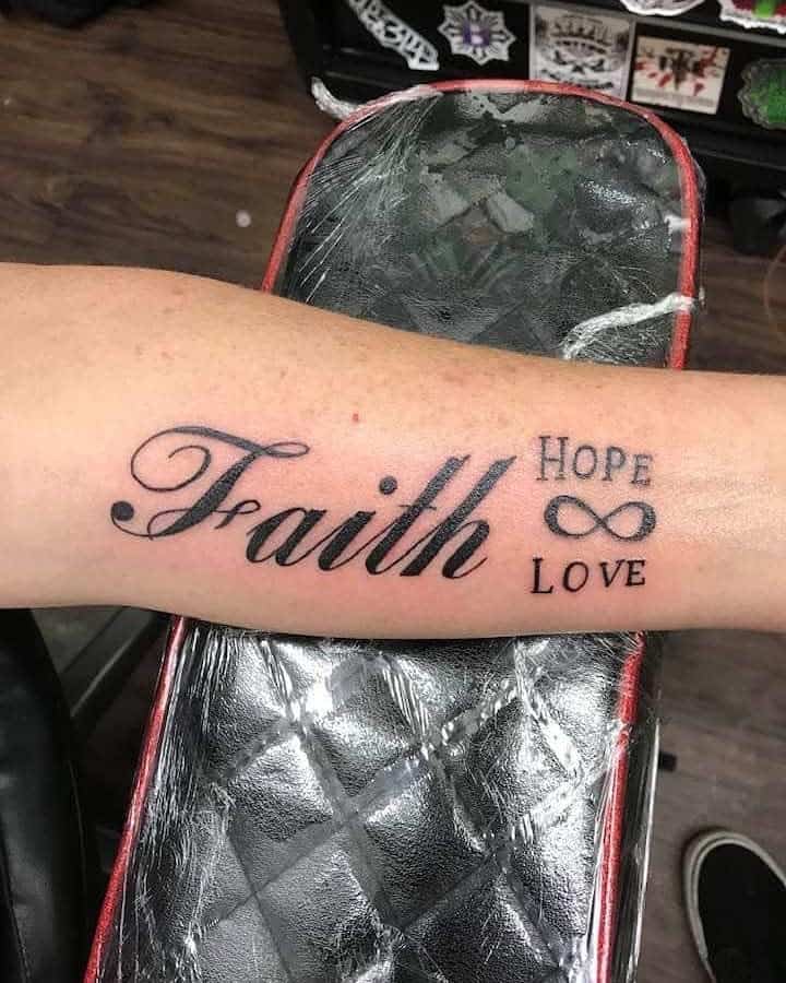 A forearm tattoo featuring the words "Faith," "Hope," and "Love" intertwined with an infinity symbol