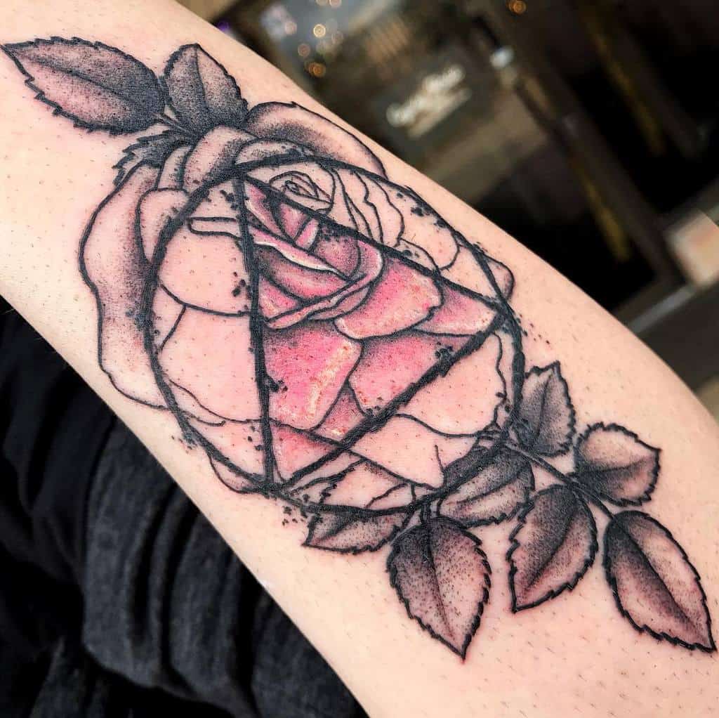 Tattoo of a rose with geometric lines and shading on an arm