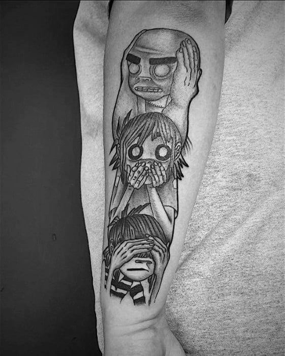 Black and grey forearm tattoo of Gorillaz members in a “see no evil, hear no evil, speak no evil” pose stacked vertically.