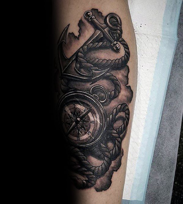 Nautical tattoo with anchor, rope, and compass on arm