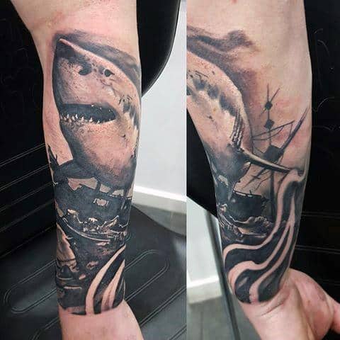 Forearm tattoo featuring a dramatic sea battle with a giant shark, sinking ship, and kraken tentacles emerging from dark ocean waters.