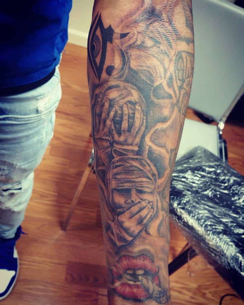 Forearm tattoo featuring 'Hear No Evil, See No Evil, Speak No Evil' imagery with detailed hands, an eye, and lips design