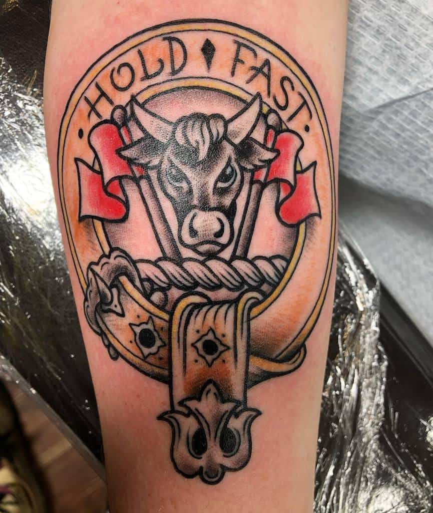 Tattoo of a bull's head with the text "Hold Fast" and red banners
