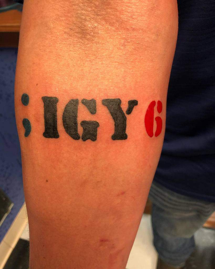 Forearm tattoo with the design "; IGY 6", with "IGY" in black and "6" in red