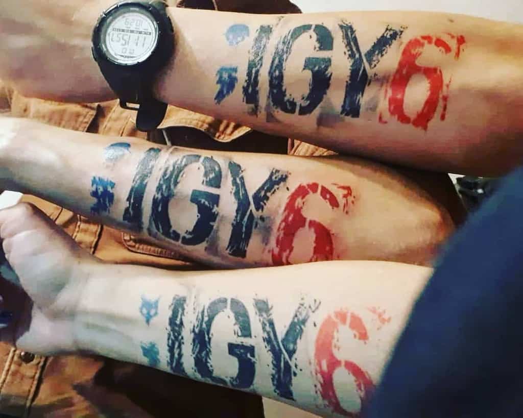 Three forearms with ";IGY6" tattoos in red and blue letters