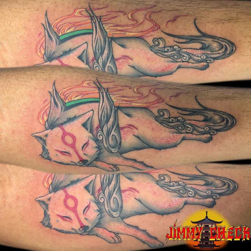 Japanese-style forearm tattoo of a peaceful, sleeping wolf with flowing tails and ethereal flames