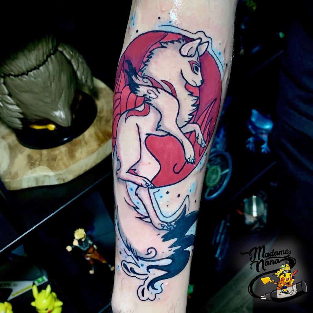 Vibrant Japanese-style forearm tattoo featuring a mythical wolf with swirling tails, leaping within a bold red circle