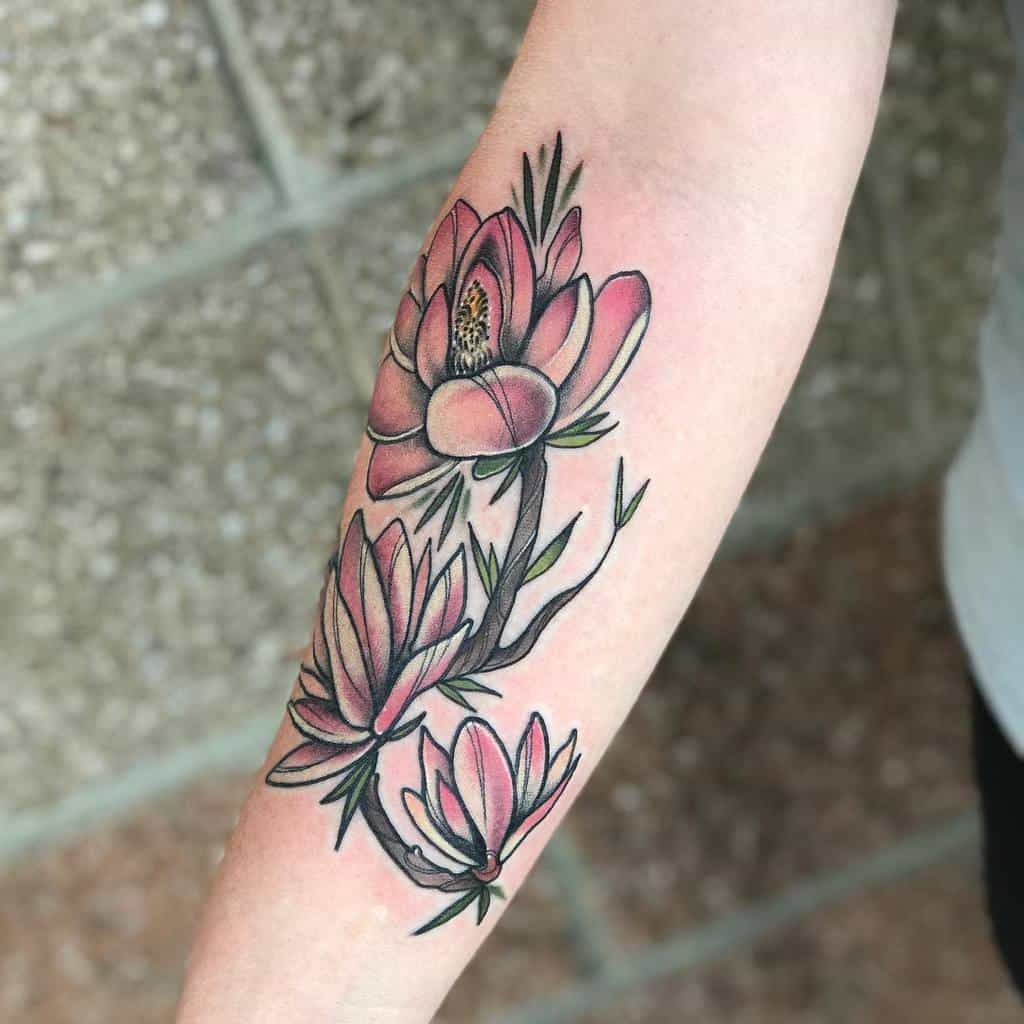 Forearm tattoo of pink magnolia flowers with green leaves