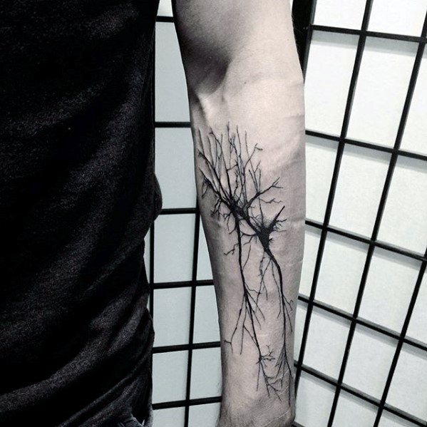 Minimalist black ink neuron tattoo on forearm with fine branching dendrites and a central darkened cell body.