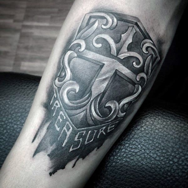 Shield tattoo with bold 3D shading, ornate scrollwork, a cross in the center, and the word PERSEVERE fading into the background.