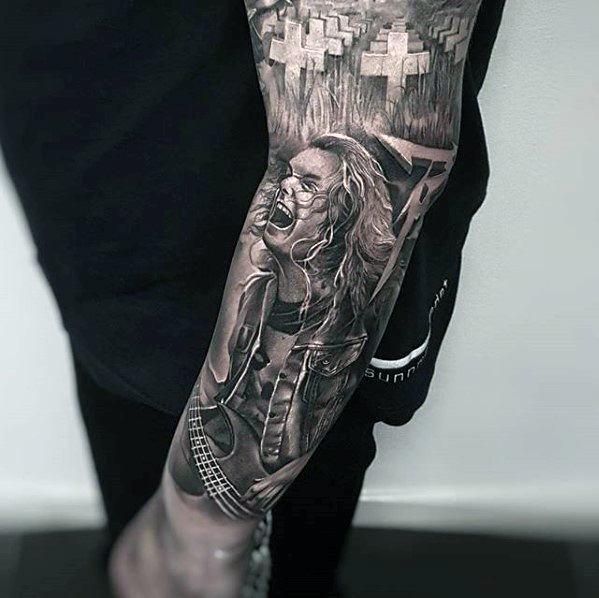 Realistic black and grey forearm sleeve tattoo of Cliff Burton playing bass, with Master of Puppets graveyard scene above.