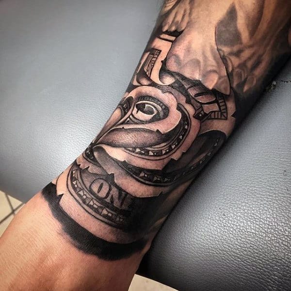 Forearm tattoo of a twisted dollar bill design forming a rose on an arm