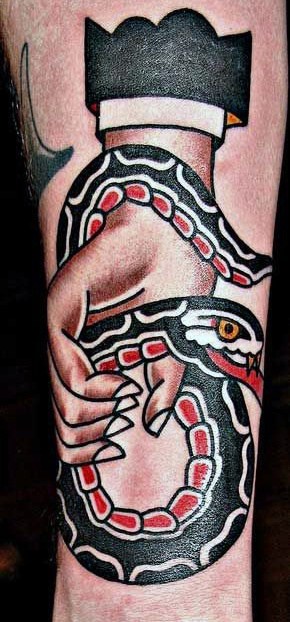 Tattoo of a hand gripping a colorful snake on a forearm