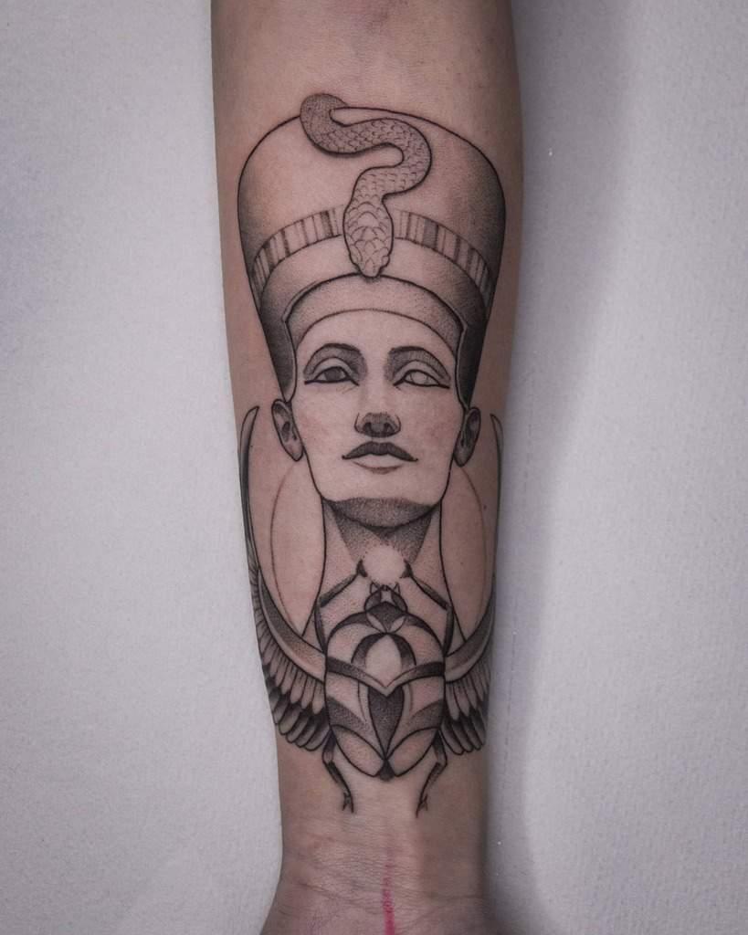 Tattoo of Nefertiti with headdress and wings on a forearm