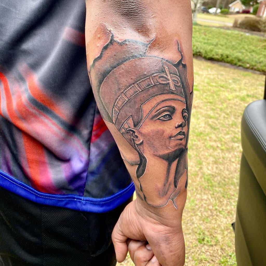 Forearm tattoo of Queen Nefertiti's bust