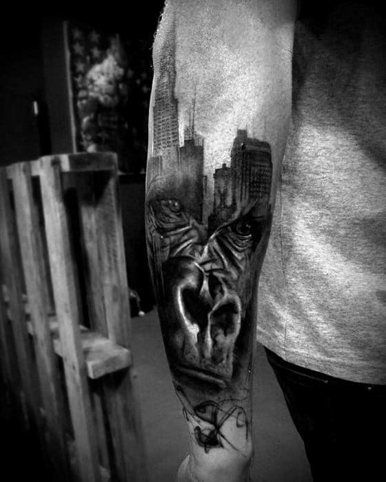 Forearm tattoo featuring the New York City skyline, intense eyes, and a dramatic heart design in black and gray realism.