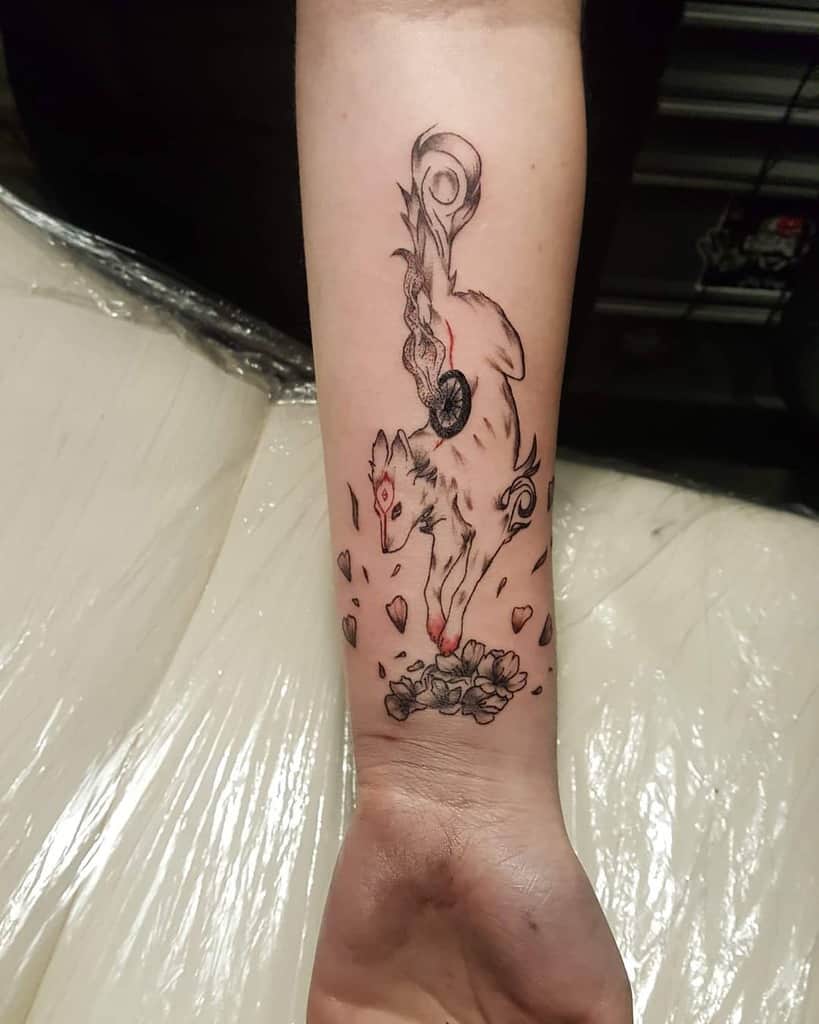 Elegant Okami tattoo on the forearm featuring Amaterasu gracefully leaping with swirling divine energy and delicate falling petals