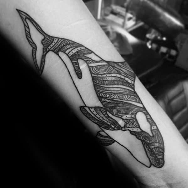 Detailed black and white orca tattoo design on the forearm, featuring intricate linework within the shape of the whale.