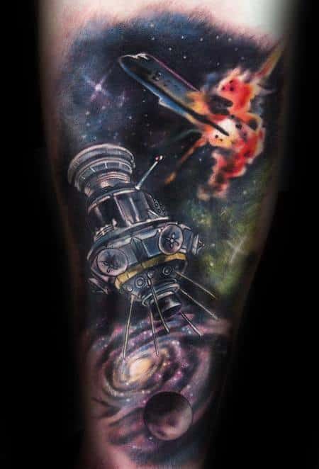 Vibrant tattoo featuring a telescope in space, a galaxy, planets, and an exploding spaceship in a cosmic scene