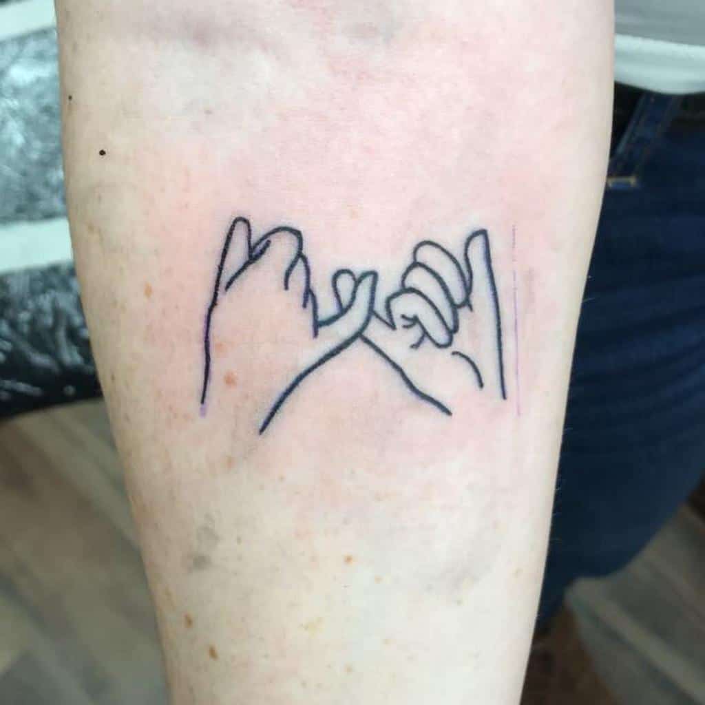 Line art tattoo of two hands with pinky fingers linked, symbolizing a promise, on a forearm
