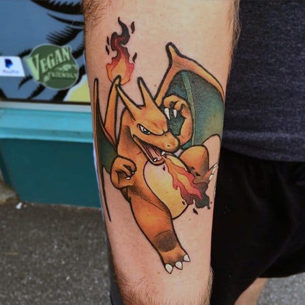 Colorful Charizard tattoo breathing fire, inked on the forearm with bold outlines and a classic animated style.