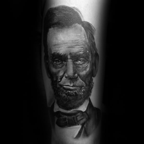 A realistic tattoo of Abraham Lincoln in a suit and bow tie