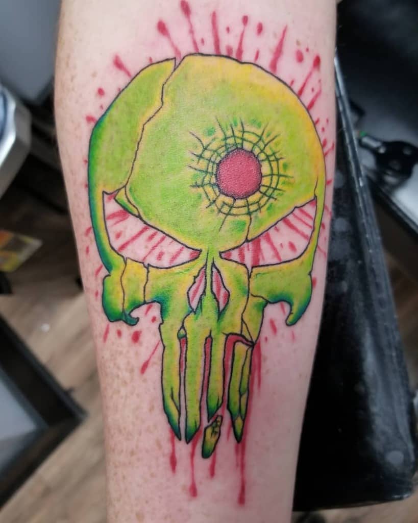 Vibrant Punisher Skull tattoo on the forearm, featuring a bold green and yellow color scheme with a cracked design and red accents for a striking, unique look