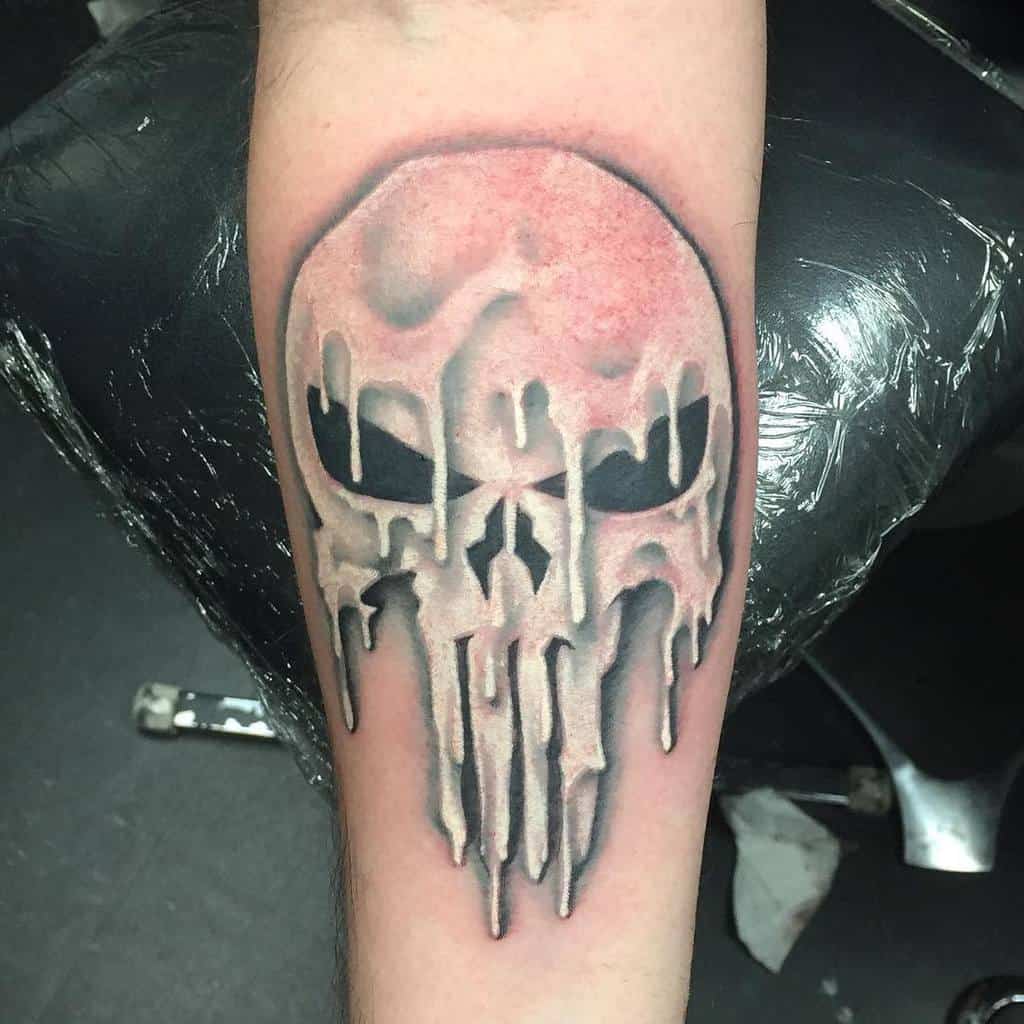Punisher Skull tattoo on the forearm with a unique melting effect, featuring dripping details and smooth shading for a striking, eerie look